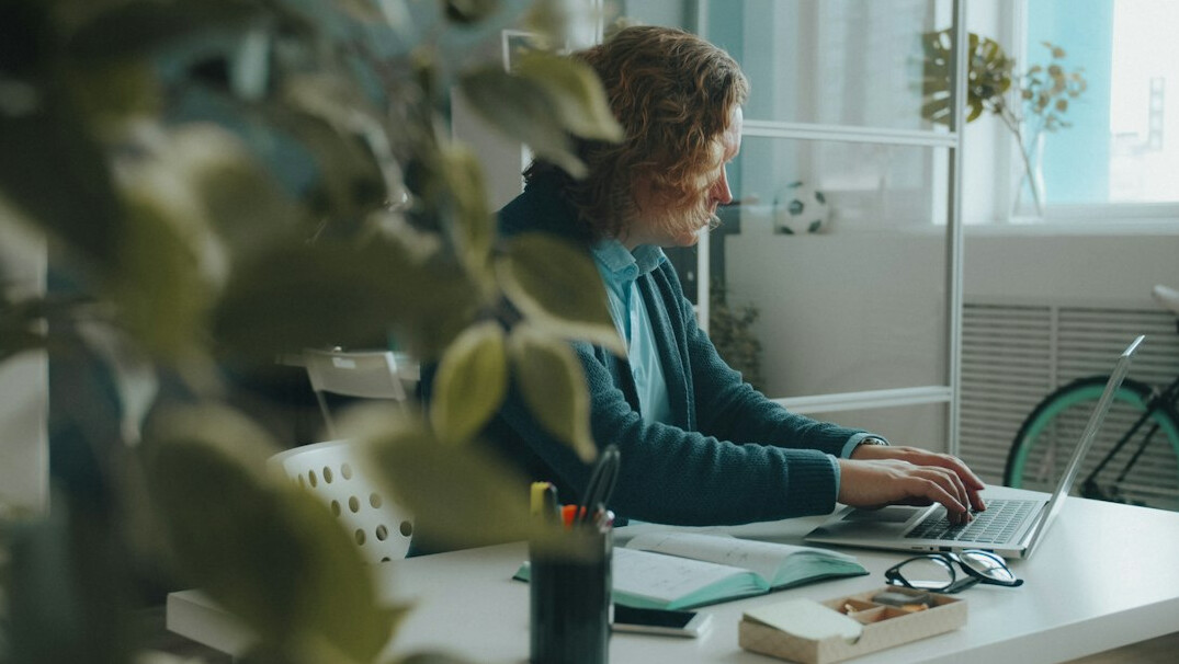 woman coding at home desk